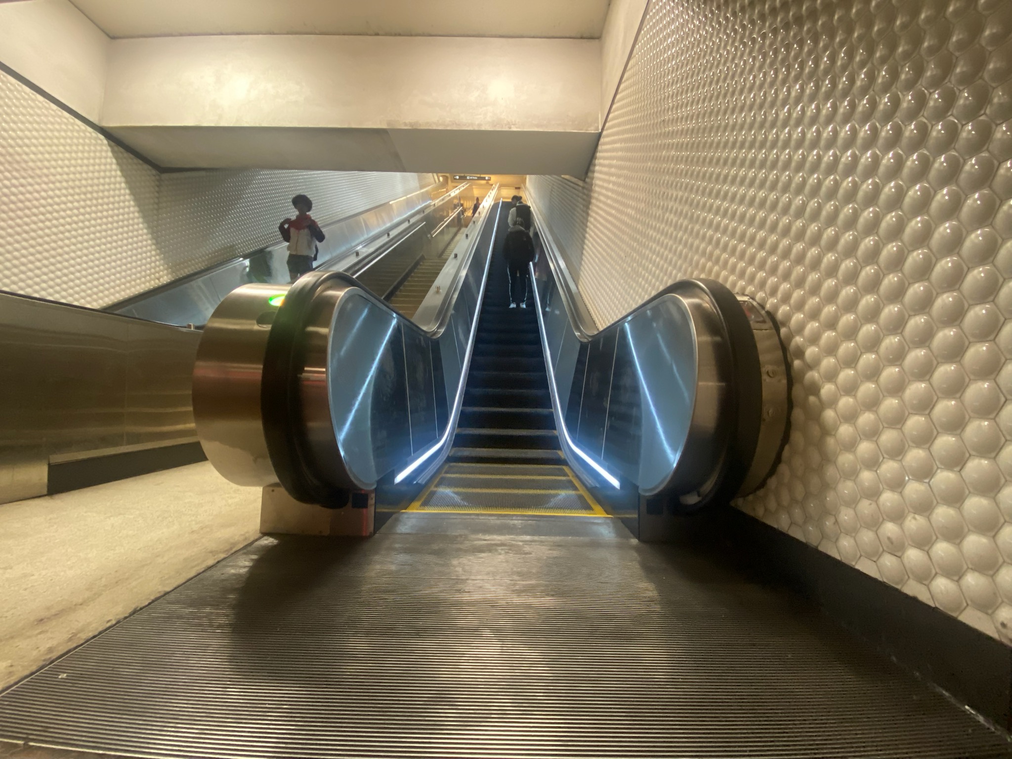 Riders on the rebuilt escalator at Montgomery St. Station
