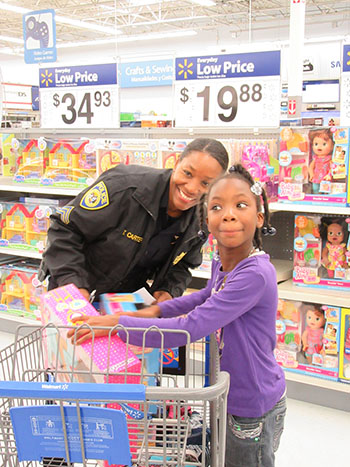 Sgt. Carter participates in the 2015 "Shop With A Cop" event to help disadvantaged children during the holidays