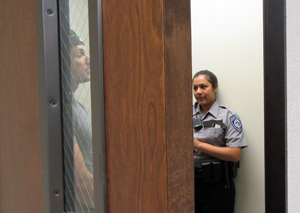 An officer role plays the perpetrator in a domestic violence case while Explorer Whitney Ibarra conducts an interview