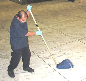 man mops station floor