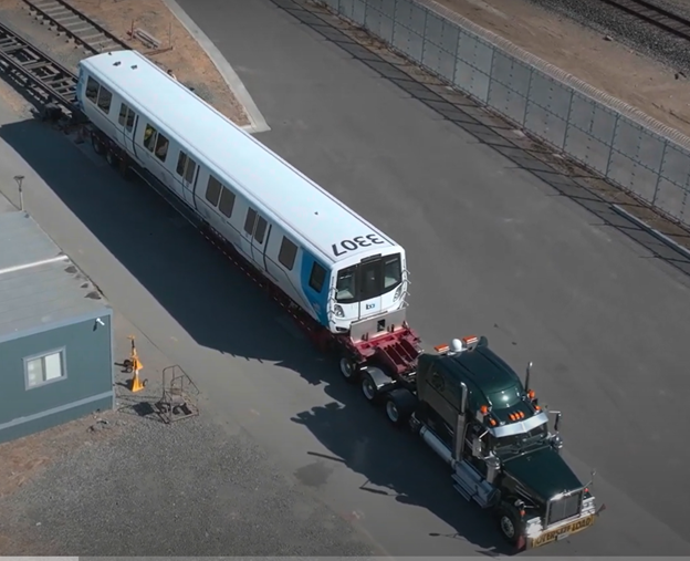 New rail car being delivered to test track on big rig truck