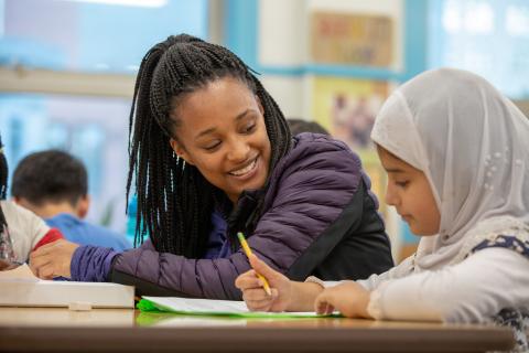 Top image: Erica Mitchell works with a student from Redding Elementary on academics at CYC’s afterschool program.   