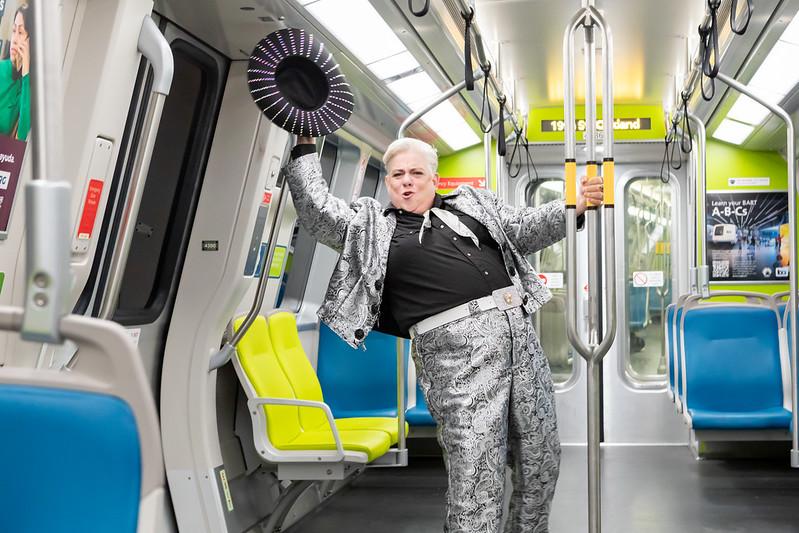 Elvis Herselvis dancing on a BART train