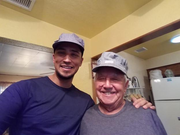 Joshua pictured with his abuelito, Luis Juarez, in matching train conductor hats. Luis was a railroad worker in his younger years. 