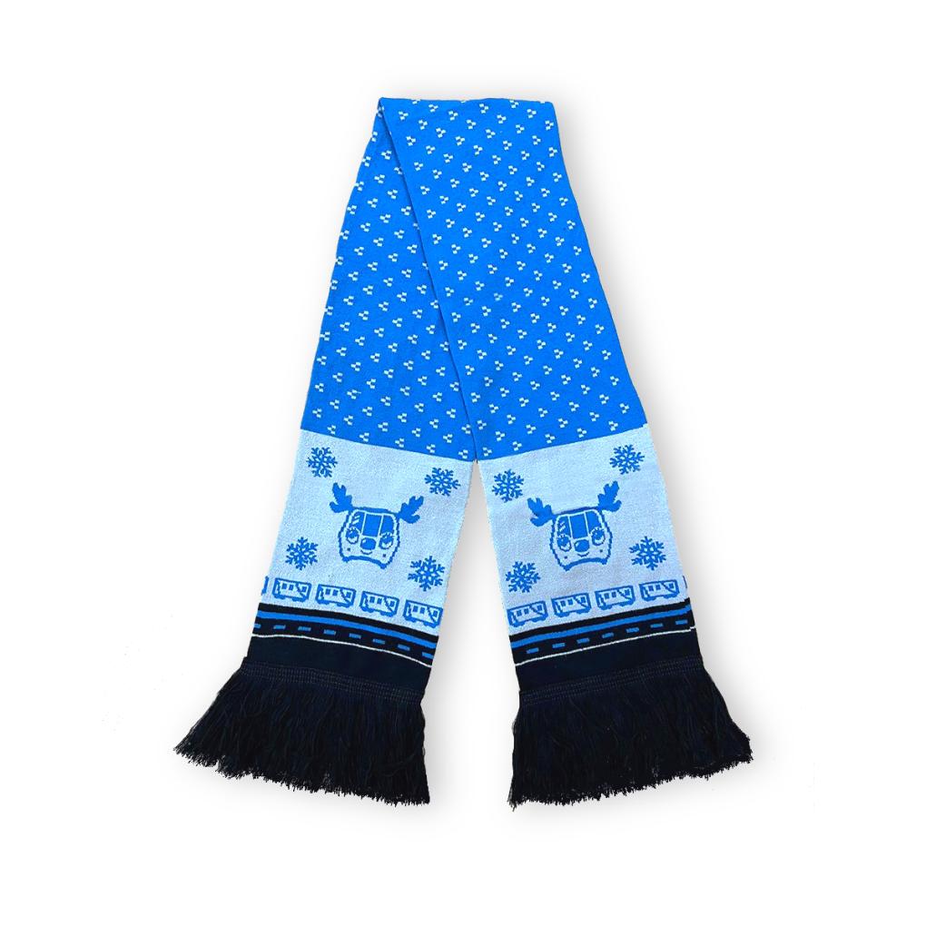The BART holiday scarf in blue with a BART train with antlers and black tassels at the bottom