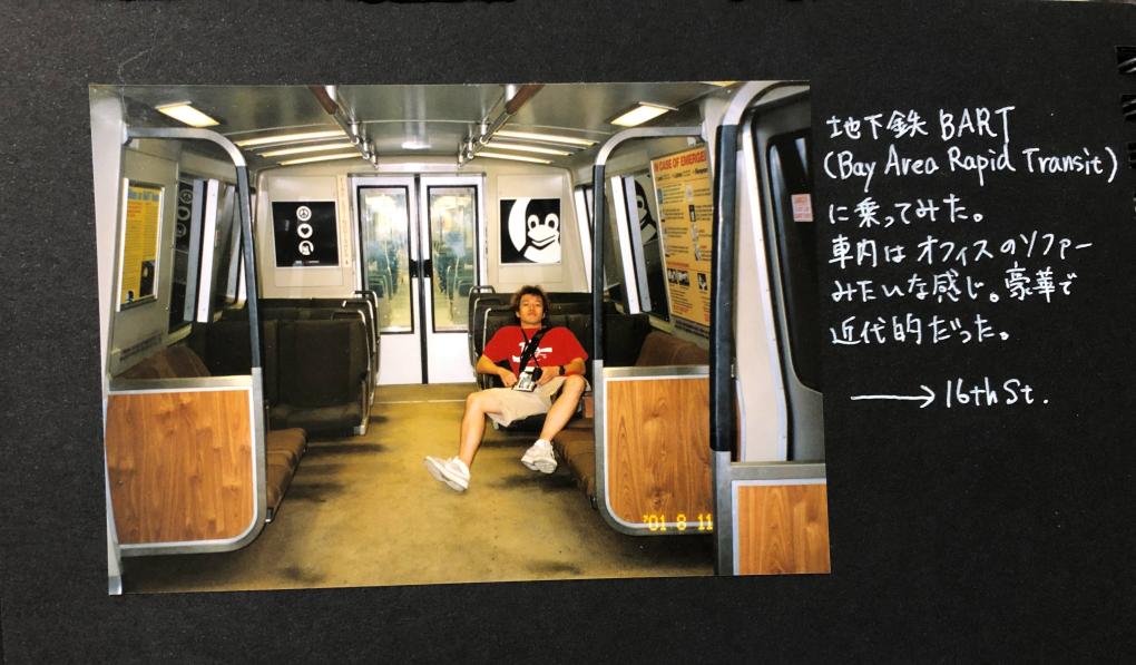 Atsushi inside a BART (Bay Area Rapid Transit) train, surrounded by empty seats and iconic BART interior design, accompanying Japanese text detailing a visit to the 16th St. station.