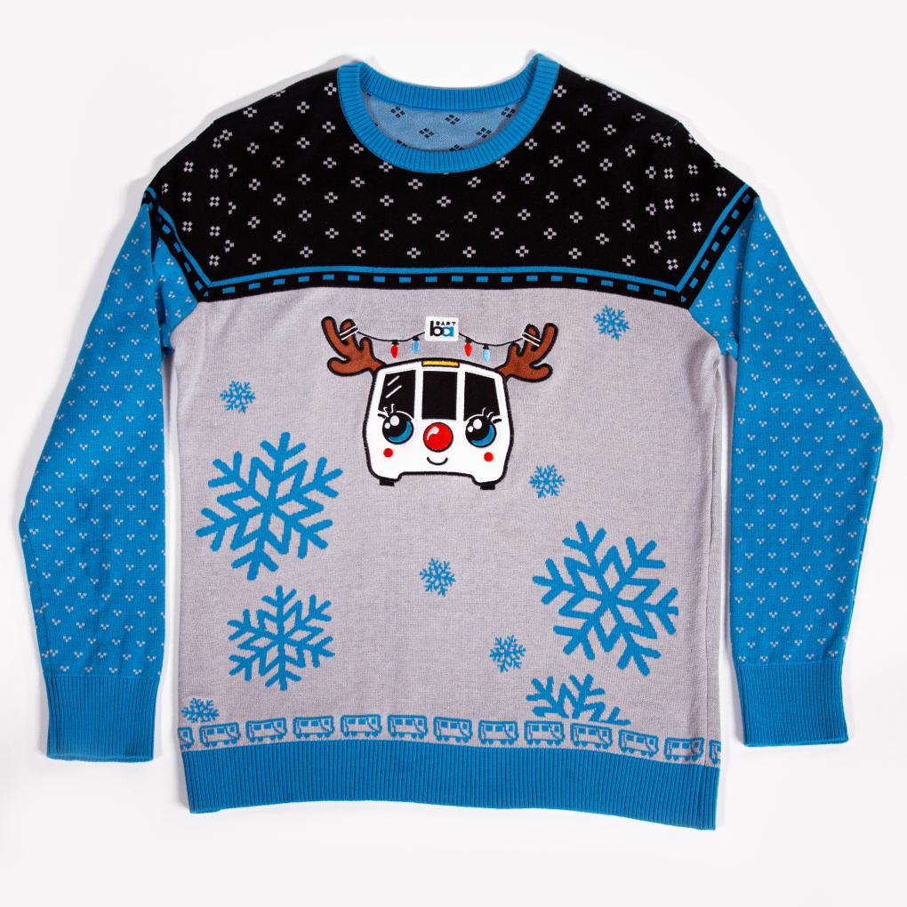 BART holiday sweater with a smiling BART train with antlers and a red nose. Snowflakes float around it. 