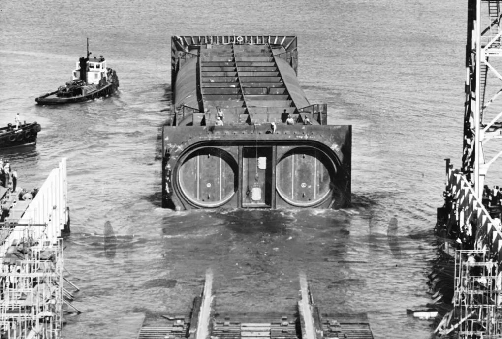 Circa 1969: A section of the Transbay Tube being floated into the Bay.